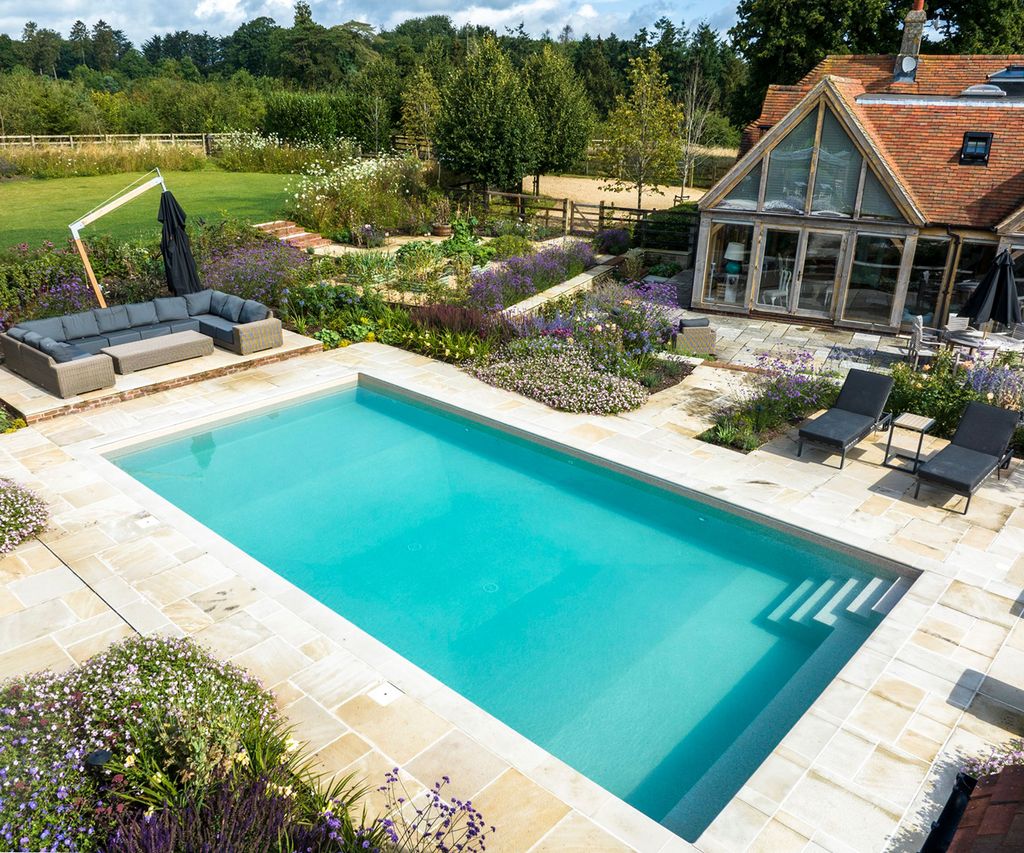 8 pool patio ideas that will elevate your poolside oasis | Homebuilding