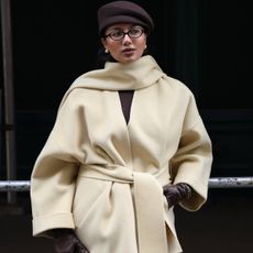 mayisha wearing a handbag and coat