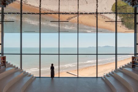 sun tower by open architecture, a curved, sloping, concrete tower, half open to the elements and looking out towards the sea