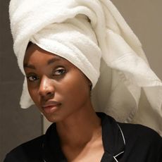 Natasha Ndlovu taking selfie with hair wrapped in a towel