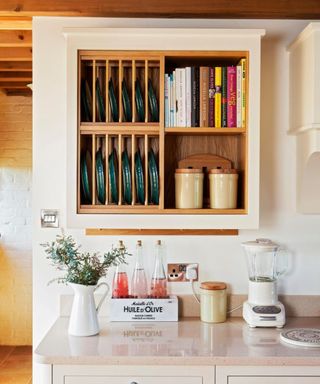 Wood fitted kitchen storage shelf, white kitchen units, marble worktop.