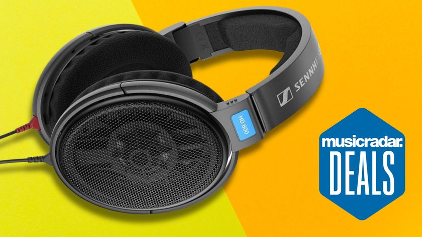 A pair of Sennheiser HD 600 studio headphones on a yellow and orange background