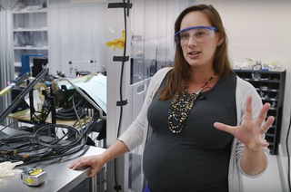 Claire Poppett, lead fiber scientist for DESI, works with a team of engineers to prepare fibers for future data rmeasurements. This is a still from an Oct. 4 Berkeley Lab video in which she explains the lab's fusing technique.