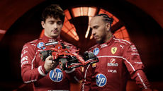 Lego Technic Ferarri SF-24 F1 Car with Charles LeClerc and Lewis Hamilton holding it