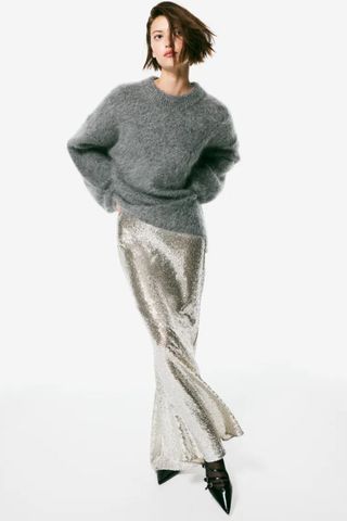 best party outfits - woman wearing silver sequin maxi skirt and grey fluffy jumper