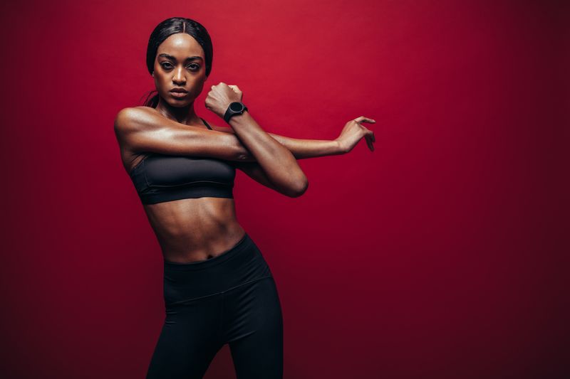 A woman pulls her arm across her body to stretch