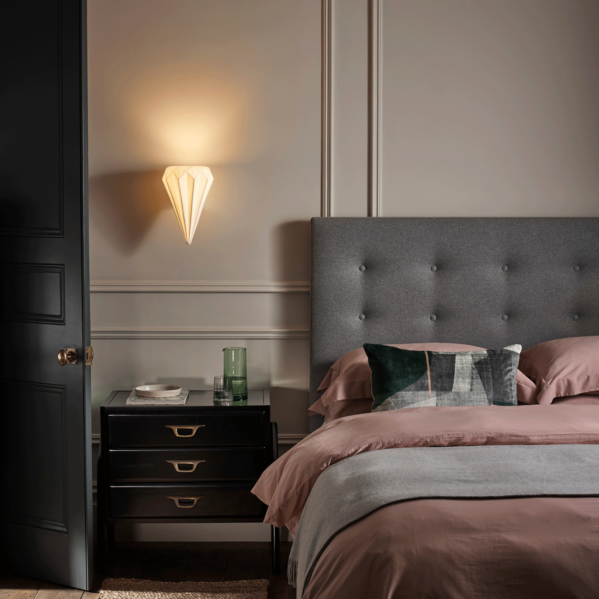 Grey bedroom with headboard and white light fitting