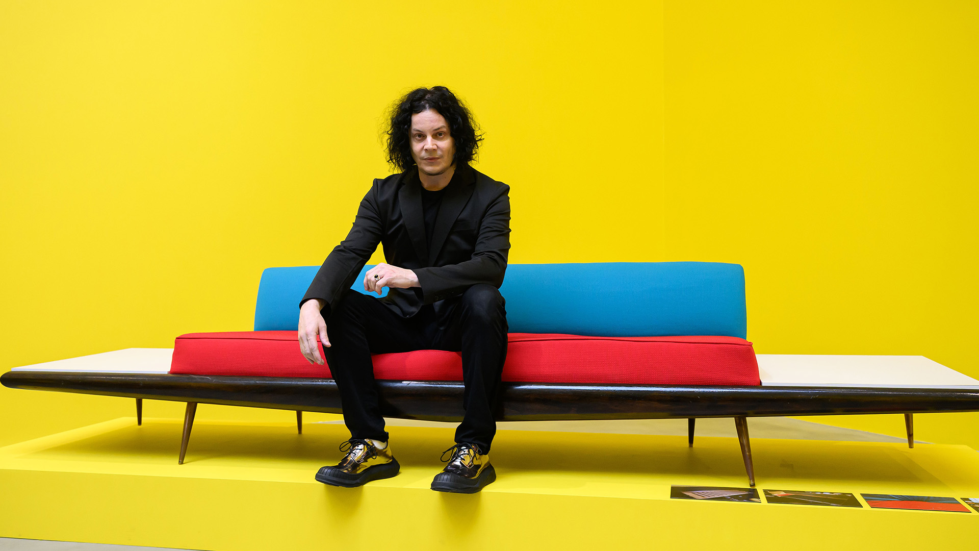 US musician and artist Jack White sits on "Sam Phillips Sofa" (2016) as he attends a photocall for the "Jack White: These Thoughts May Disappear" exhibition at Newport Street Gallery on May 28, 2026 in London, England. The exhibition marks the first public presentation of works by the American artist and musician Jack White, featuring his monumental sculpture The Red Tree (2015). (Photo by Leon Neal/Getty Images)