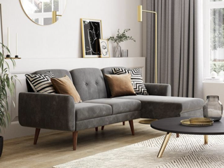 grey L-shaped sofa bed with brown and monochrome cushions