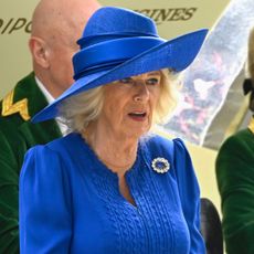 Queen Camilla in a blue dress and hat at Royal Ascot