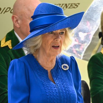 Queen Camilla in a blue dress and hat at Royal Ascot