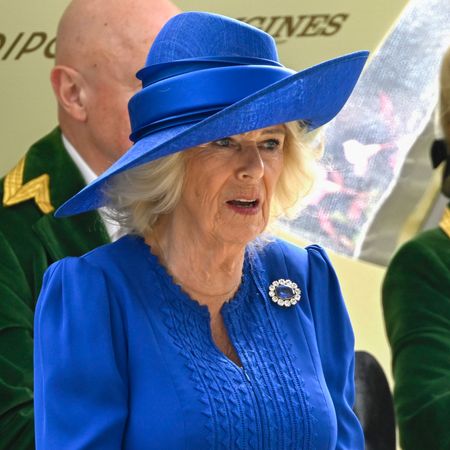 Queen Camilla in a blue dress and hat at Royal Ascot