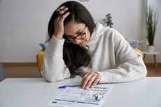 Woman looking at energy bills