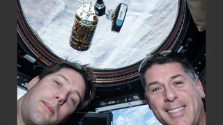 Astronauts Thomas Pesquet and Shane Kimbrough snap a selfie with the HTV-6 resupply ship orbiting a short distance away from the space station’s cupola on Dec. 13, 2016.