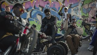 A gang wear facemasks and sit around on motorbikes in Netflix's The Kitchen movie