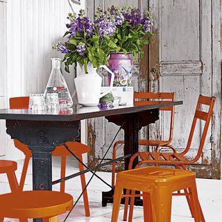 dining room with black table and orange stool