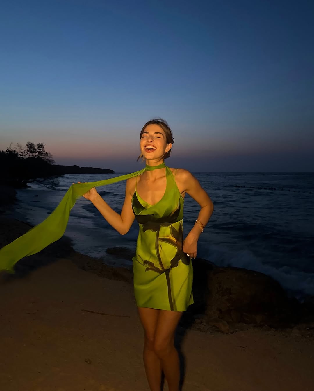 woman wearing green mini dress with neck scarf