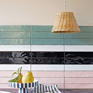 kitchen with tiles in striped pattern, cake stand and wicker lampshade