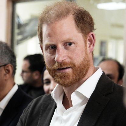 Prince Harry wearing a white shirt and black blazer