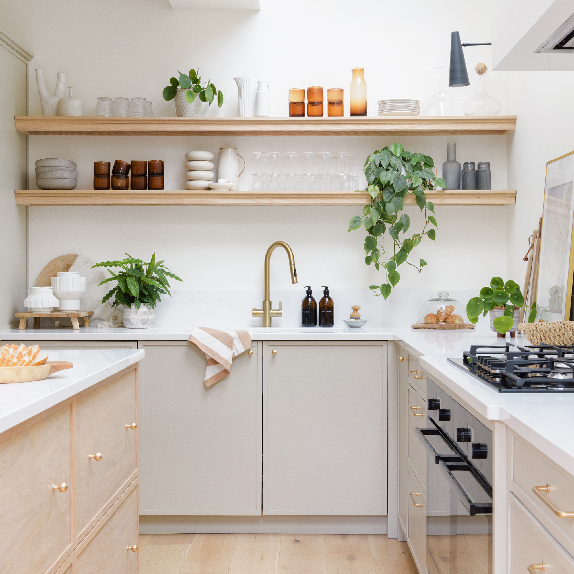 white kitchen with open shelving, timber flooring and wood kitchen island 
