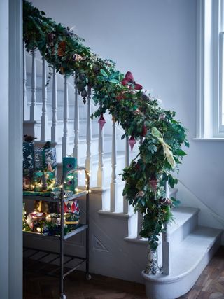 Evergreen garland on white staircase