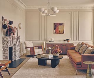 Living room with marble fireplace and chairs around coffee table