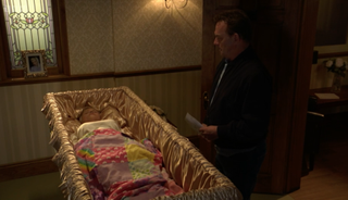 Lola lies in her coffin as Billy visits her before the funeral in EastEnders
