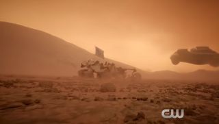 A spaceship streaks over Mars, with a U.S. rover clearly in view, in this still from a trailer for the "Supergirl" episode "Far from the Tree" airing Oct. 23, 2017.