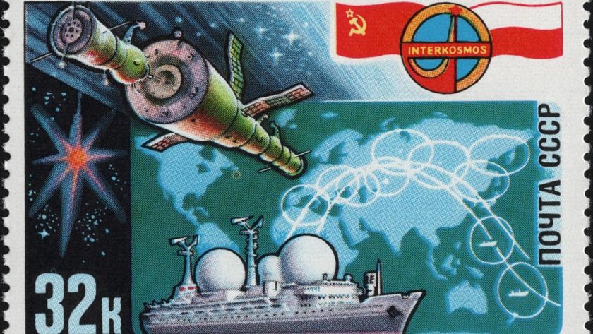 a cylindrical space station with two solar panels extending from it at perpendicular angles