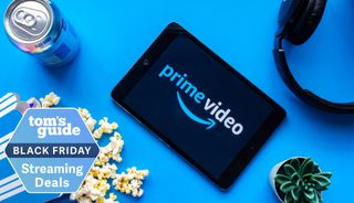 Prime Video logo appears on a tablet surrounded by a can of soda, spilled popcorn, headphones and a cactus with a Tom's Guide streaming deals badge.