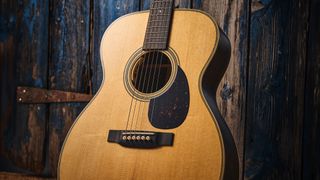 Martin OM-28E with L.R. Baggs Anthem is a stunning update on a classic acoustic, with top-class electronics. Here it is photographed in close-up and against a door with a distressed blue paint-job.
