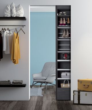 A walk-in closet area in a small space with modular shelves