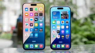 iPhone 16 Pro vs iPhone 16 Pro Max displays standing up on bench