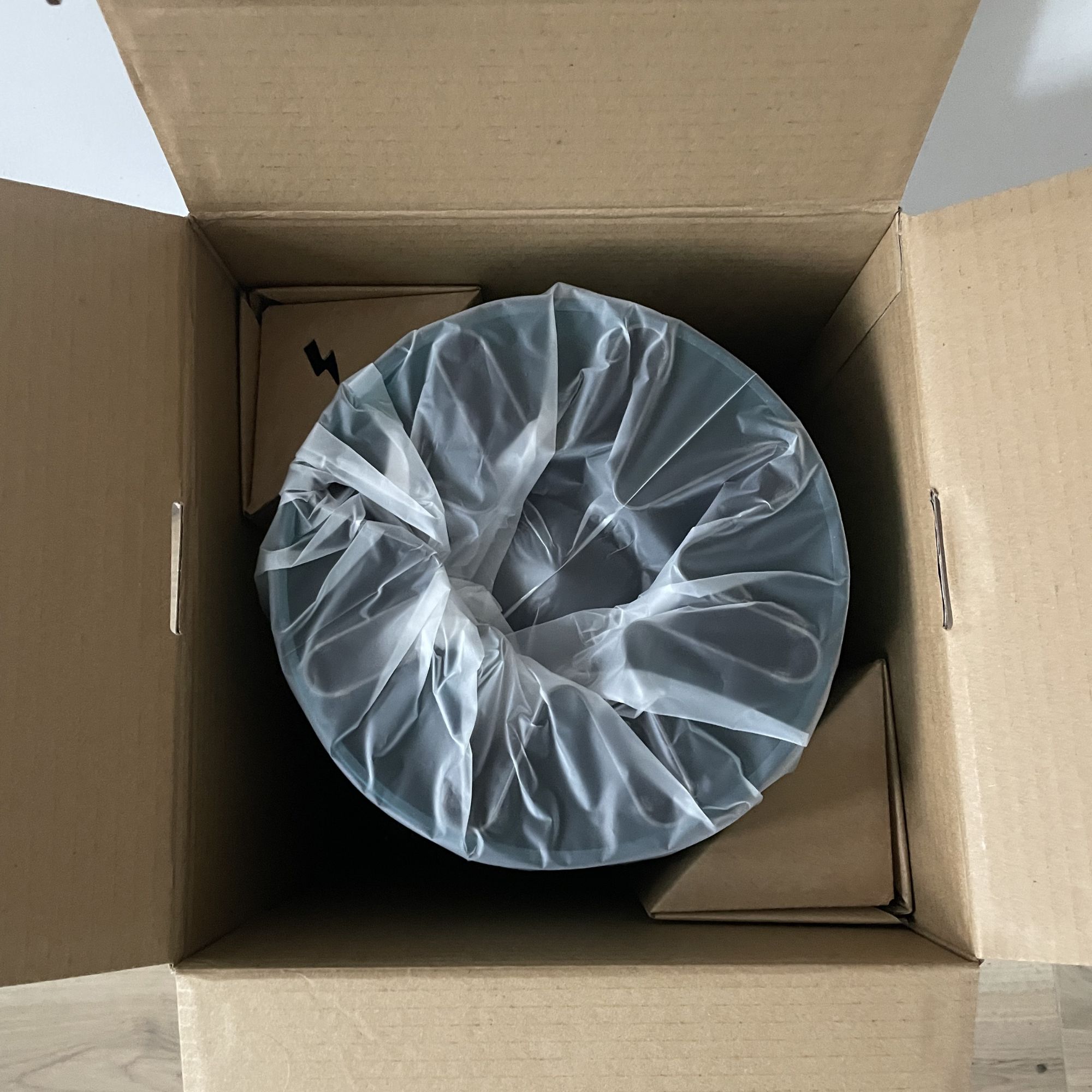 Dyson Hushjet Air Purifier wrapped in plastic, sitting in the delivery box