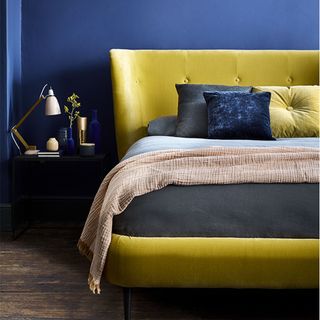 Blue bedroom with yellow velvet bed