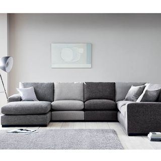 grey living room with sofa set and cushions