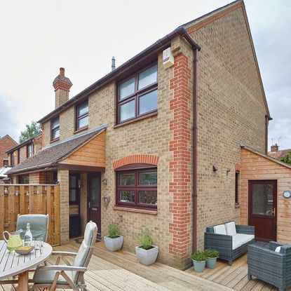 house with brick wall and wooden fence