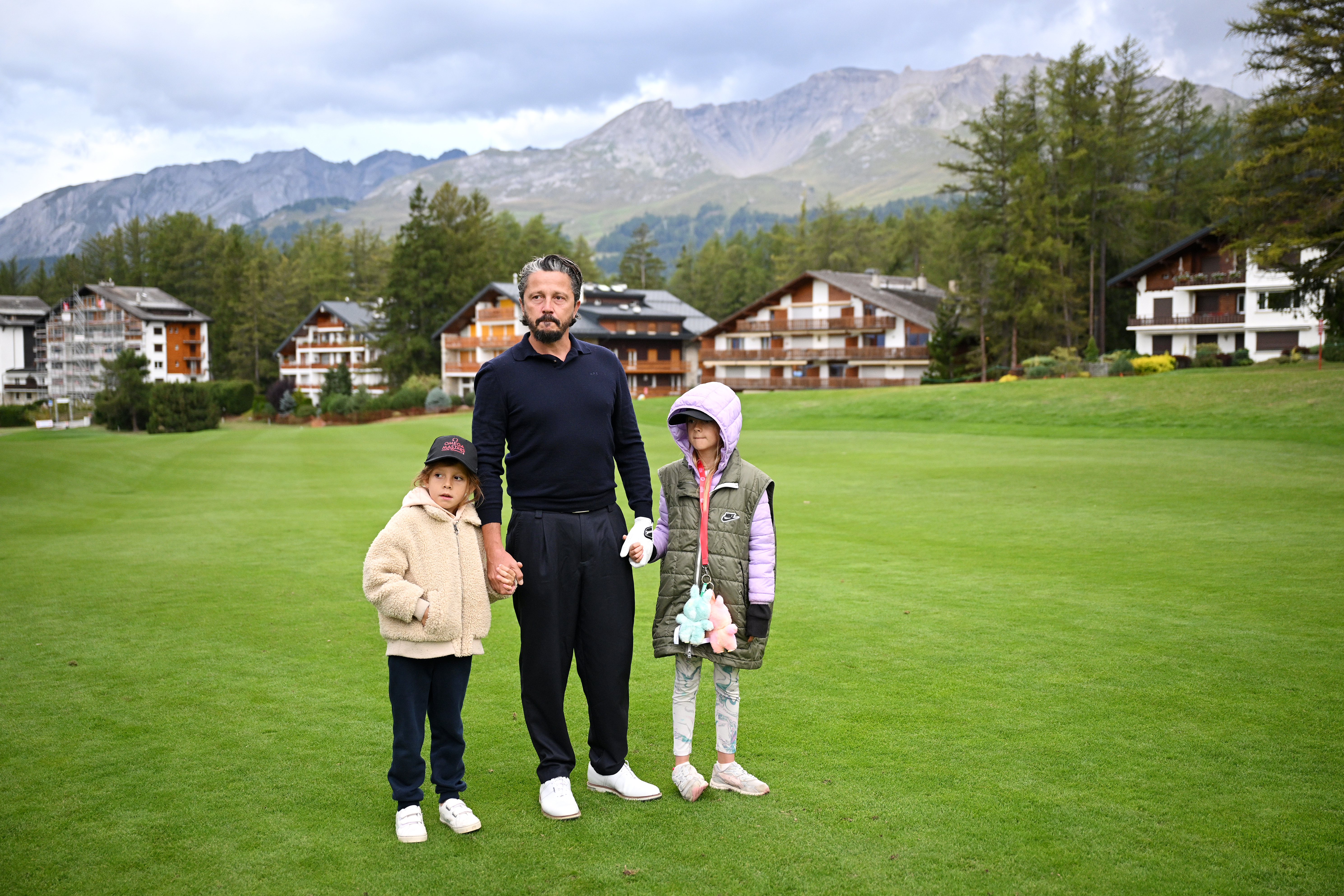 Mike Lorenzo-Vera holds his children&#039;s hands on the ninth hole at the Omega European Masters