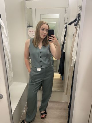 Woman in dressing room wears linen waistcoat and linen trousers