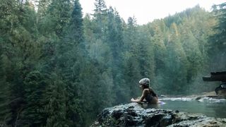 Woman bathing in hot spring in forest