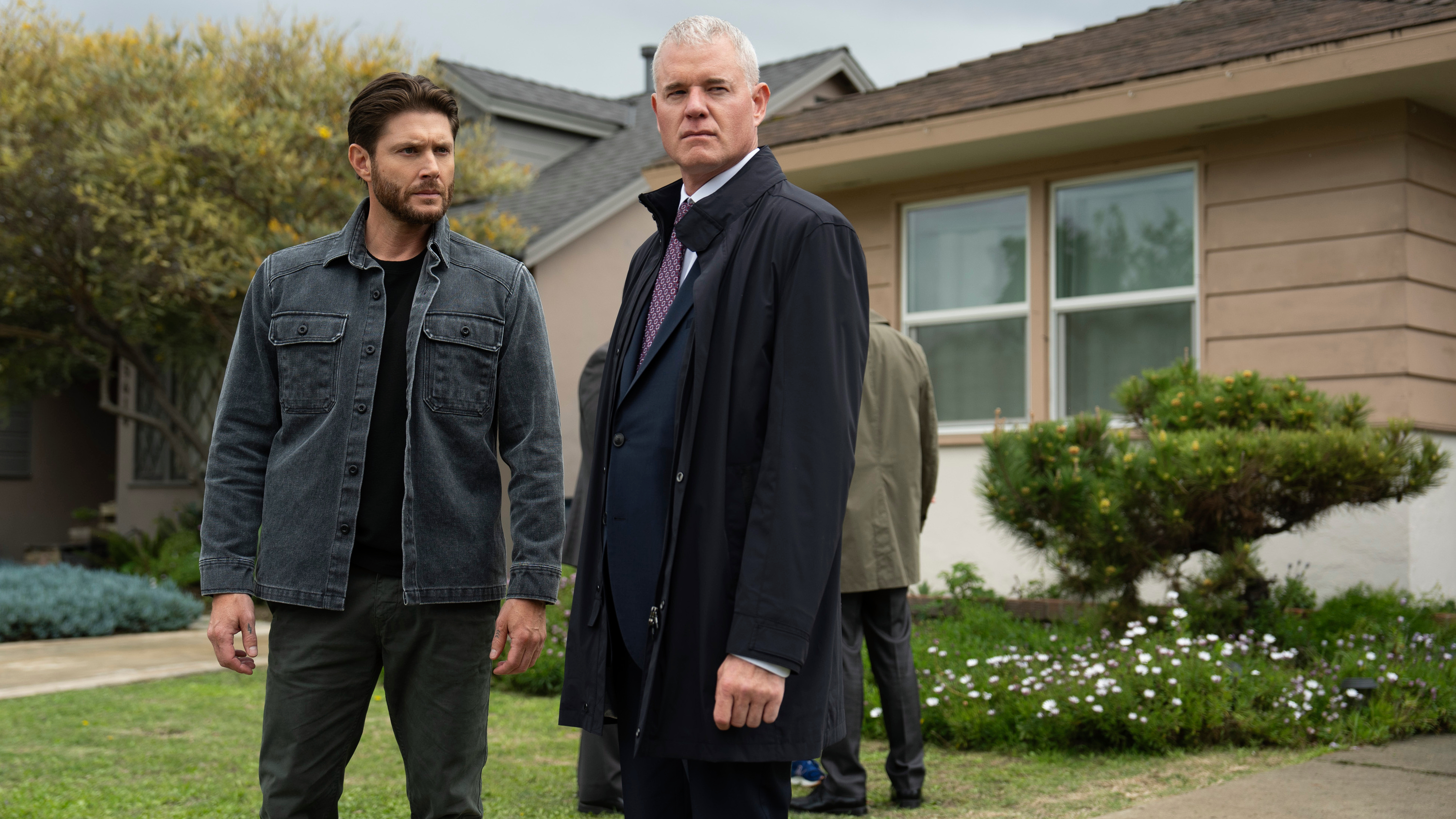 Mark Meachum (Jensen Ackles, left) and Nathan Blythe (Eric Dane) standing side-by-side outside a house in a scene from Prime Video&#039;s &quot;Countdown&quot;