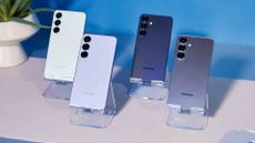 Samsung Galaxy S25 family of phones on a white table with a blue background
