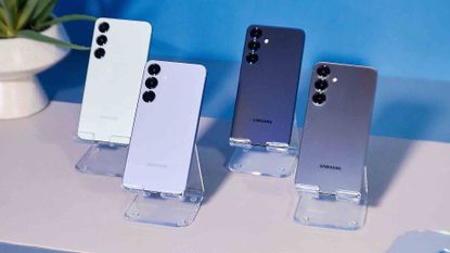 Samsung Galaxy S25 family of phones on a white table with a blue background