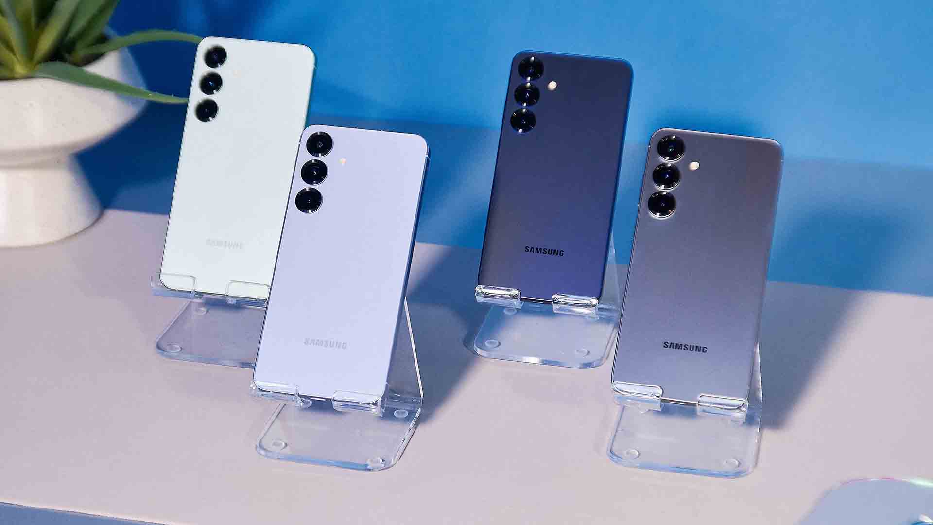 Samsung Galaxy S25 family of phones on a white table with a blue background