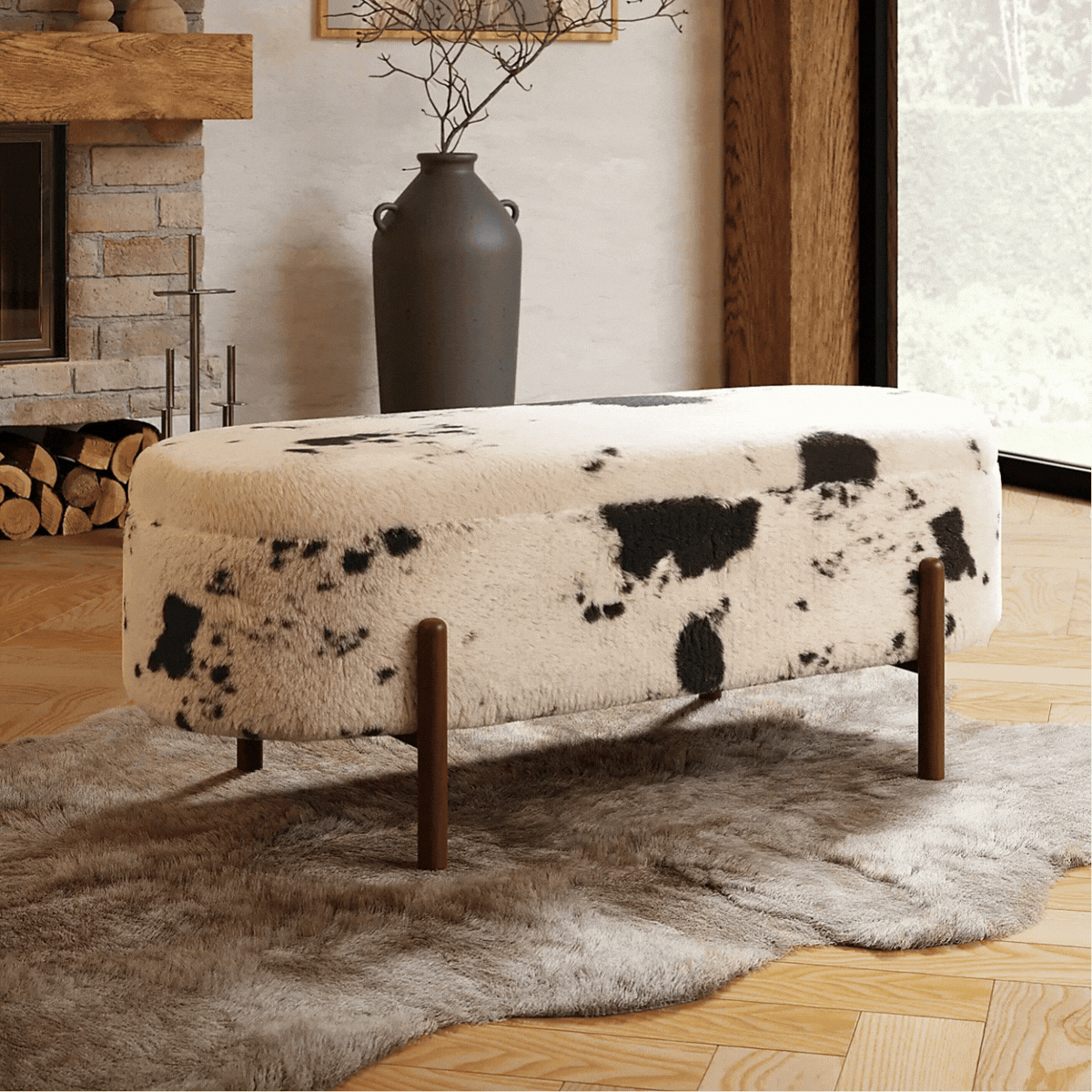 A cow print storage bench