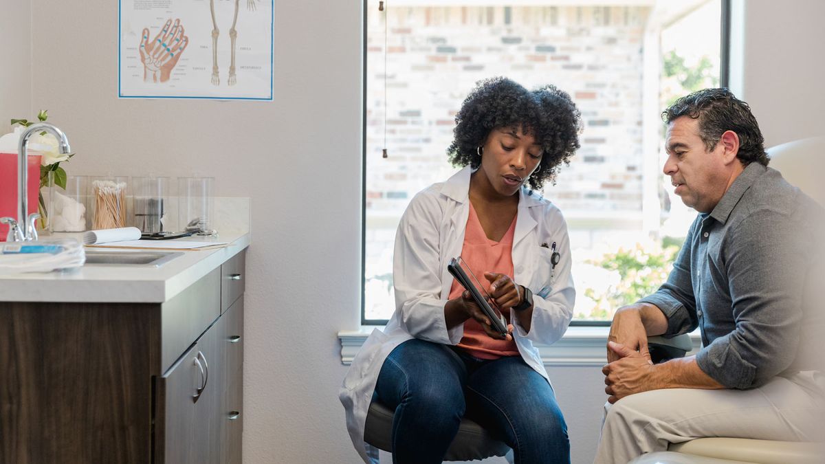 female doctor explaining something to a male patient