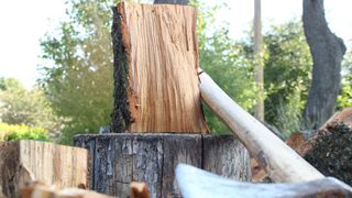 how to chop firewood: wood on a chopping block and an axe