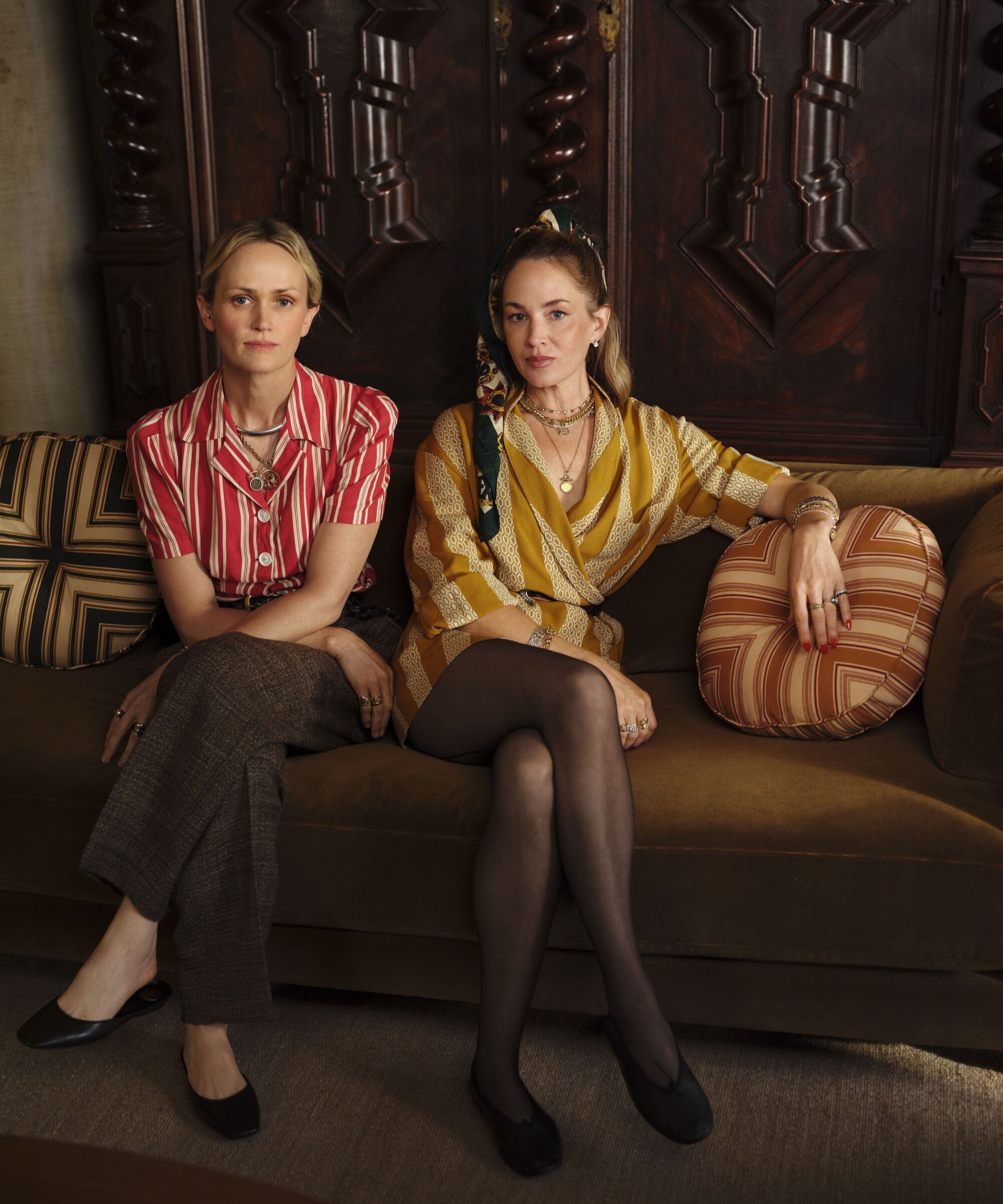 designers from Pierce &amp; Ward sitting on a brown sofa with striped cushions