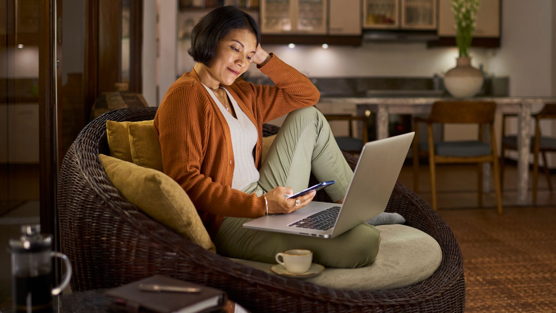 Woman sitting on sofa with laptop