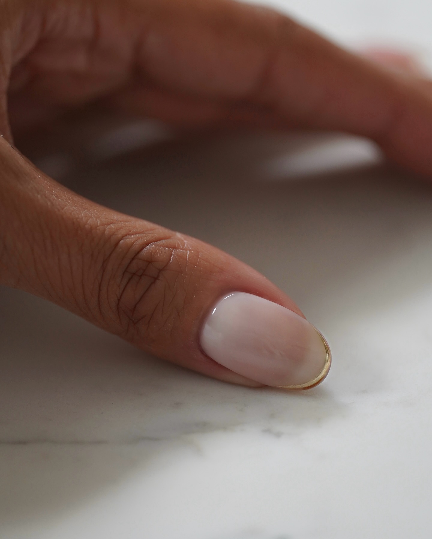 A milky white manicure by Iram Shelton